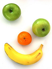 face made of 2 green apples, an orange & a banana