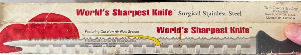 Packaging for the "World’s Sharpest Knife," showing a serrated blade cutting a red tomato and marketing text.