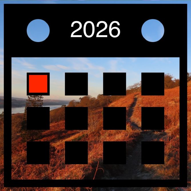 A 2026 calendar overlaying a landscape of hills with winter foliage and a distant body of water.